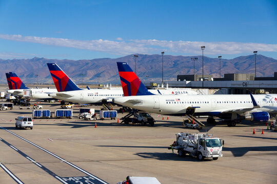 Delta Air Lines Aircraft Tails at Salt Lake City International Airport Terminal with Wasatch Range in Background, Utah