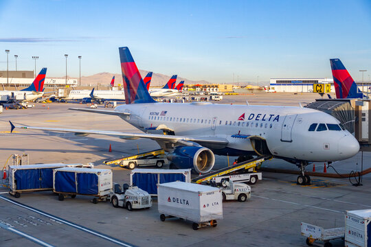 Delta Air Lines Airbus A319 at Gate with Delta Fleet and Wasatch Range Backdrop at Salt Lake City International Airport, Utah