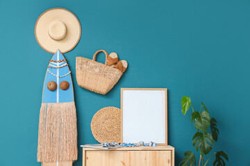 Interior of room with surfboard, beach accessories and blank frame