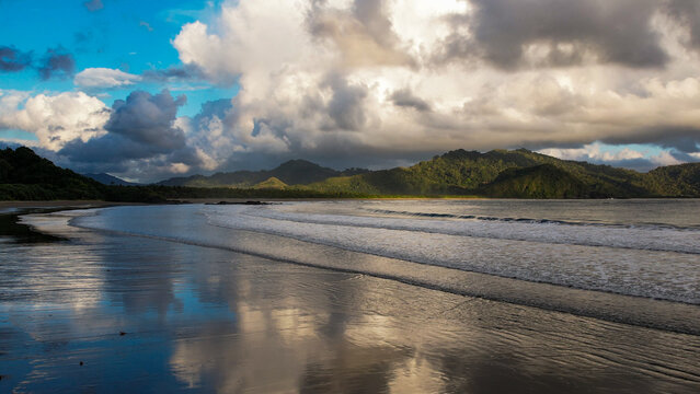 Calm Indian Ocean shoreline and forested headlands, Java Indonesia