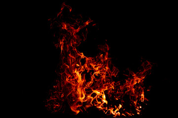 Flame texture glowing in darkness. Flame sparks creating light effect. Flame burning abstract form. Flame black background.