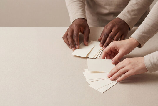 Hands arranging blank flashcards
