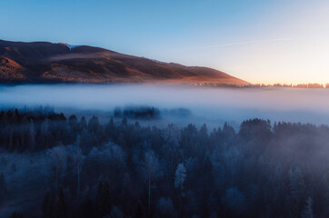 Aerial view of Liptov region at sunrise with High Tatras mountains in the background, Slovakia