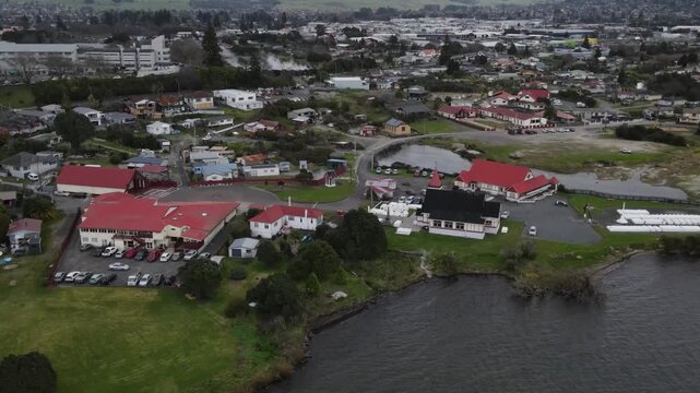 Drone crane shot of Ohinemutu on Lake Rotorua lakeside. Maori culture heritage, living village.