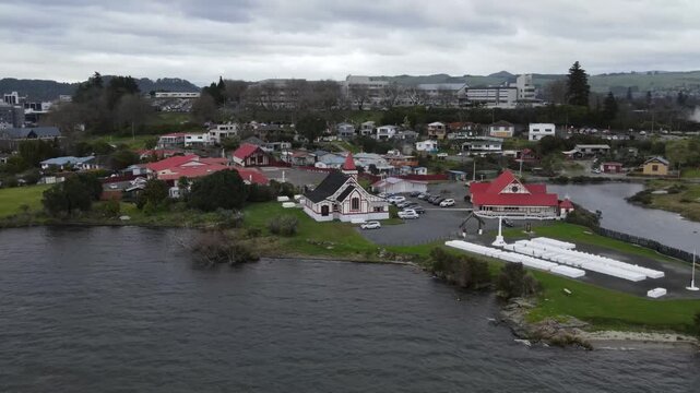 Ohinemutu Maori village on lakeside of Rotorua, drone urban landscape. History, documentary.