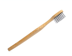 Natural bamboo toothbrush with soft bristles on white background