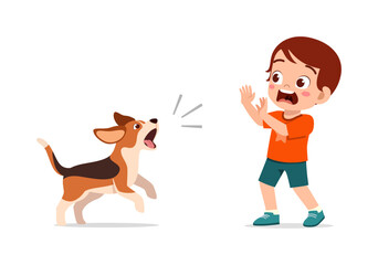 Little boy scared surprised by a barking dog an aggressive pet dog making the child afraid with hands up