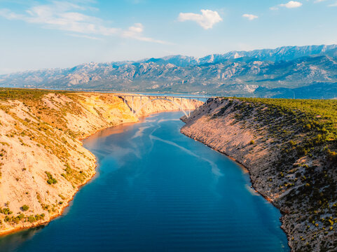 Maslenica Bridge spanning the Novsko zdrilo strait on Croatia&rsquo;s Adriatic coast. Red steel structure  with the turquoise sea and rugged cliffs near Zadar and Paklenica and Velebit national park