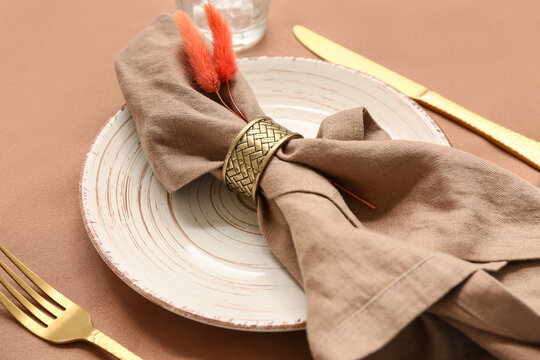 Beautiful table setting with dried lagurus on napkin, closeup