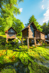 Historic wooden watermills (Mlincici) on the travertine barriers of Plivsko Lake near Jajce, Bosnia and Herzegovina.