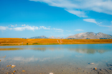 Deep blue waters of Vrazje Jezero (Devil's Lake) on the high plateau of Durmitor National Park, scenic mountain lake landscape in Montenegro.