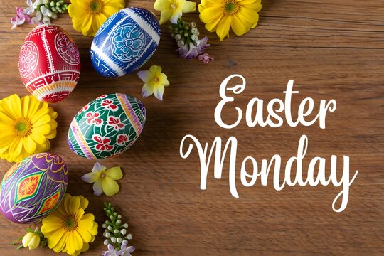 Celebrating easter monday with colorful decorated eggs and yellow flowers