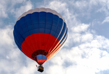 Fototapeta premium Hot air balloon in the color of the Russian flag at sunset