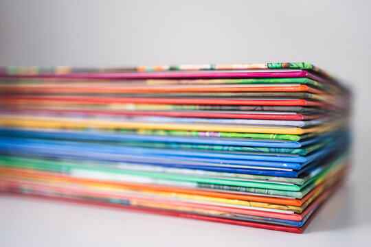 pile of colorful children books on white desk with shallow depth of field