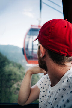 Man in gondola looking toward cable car in Glenwood Springs, Col