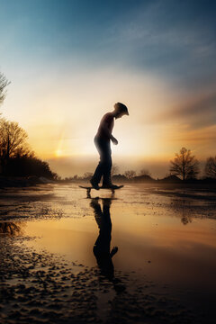 Silhouette of Boy Skateboarding at Sunset