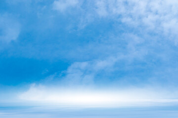 Obraz premium A bright, clear blue sky meets a glowing white horizon, suggesting a serene, open, and with sunlight of beautiful cloudy sky. landscape or abstract background