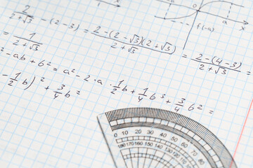 Naklejka premium Copybook with handwritten maths formulas and semicircular protractor as background, closeup