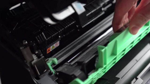 Steps to change the toner in a printer at an office in the afternoon