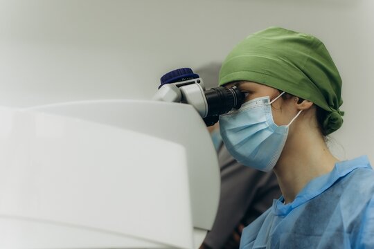 Ophthalmologist performing eye surgery with medical microscope