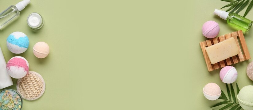 Different bath bombs and cosmetic products on green background with space for text