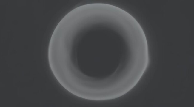 A soft, glowing torus shape in a dark, gray environment