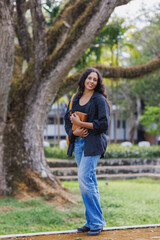Young woman student carrying books in a campus