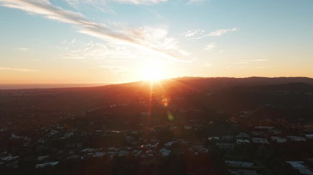 Wide dolly shot of the sun setting over Beverly Hills in Southern California. 4K