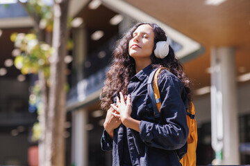 Woman enjoying music and finding peace outdoors
