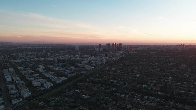 Wide panning aerial shot of The Flats neighborhood at sunset in Beverly Hills, California. 4K