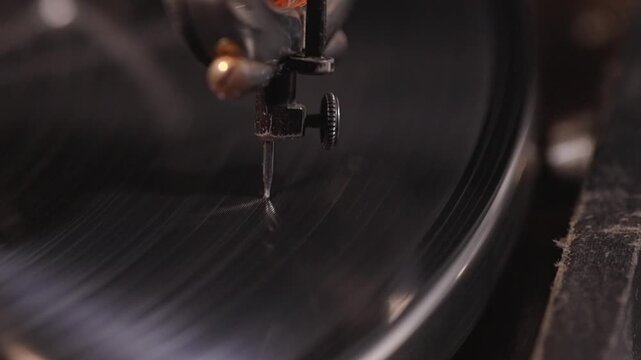 Macro close-up of stylus needle touching spinning vinyl record on a classic turntable. Retro analog music playback concept, nostalgic sound technology and vintage audio equipment.