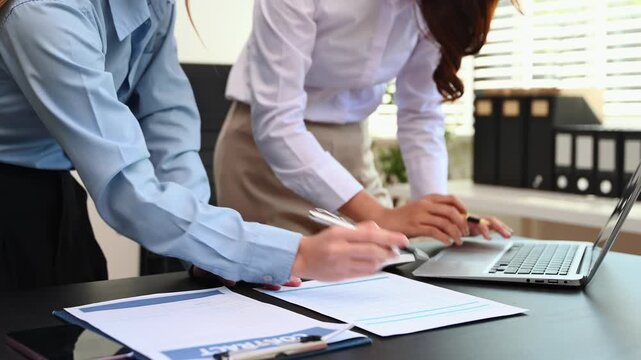 Businesswoman and team analyzing financial statement Finance task. with smart phone and laptop and  tablet. Wealth management