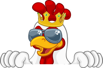 A chicken rooster cockerel bird cartoon character in a kings gold crown and cool shades or sunglasses peeking over a sign © Christos Georghiou