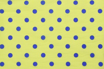 Polka dots blue on yellow fabric pattern background © Boonsawad