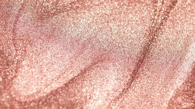 Macro shot of copper paint flowing diagonally to create thick ridges and waves, highlighting a sandy texture and radiant sparkling glitter particles