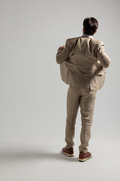 Modern man adjusting jacket and looking away