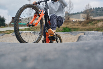Close up of child riding bicycle on pump track