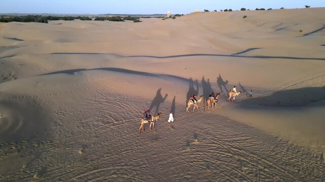 Aerial View of Tourists Enjoying Camel Ride in Jaisalmer Thar Desert Rajasthan India