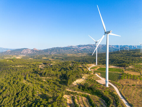 Wind turbine aerial scene with road through Terra Alta Catalonia Spain showing renewable energy sustainability and clean power infrastructure