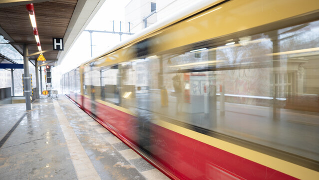 train speeding through urban station