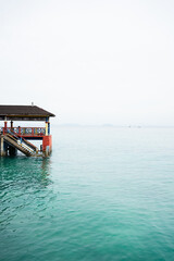 Fototapeta premium Colorful pier extending over turquoise ocean water
