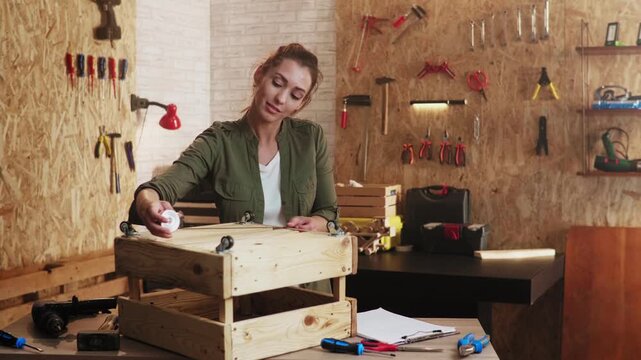 Female vlogger recording a diy furniture tutorial in a workshop