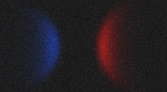 Two glowing orbs blue and red on dark grainy textured surface