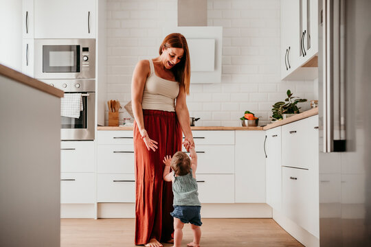 Mother and baby bonding in modern kitchen and sharing quality time