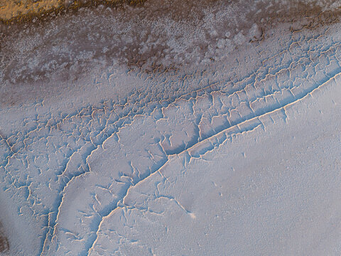 Aerial view of cracked earth revealing a parched landscape with an intricate network of fissures and dry textures, Lake Campion, Western Australia, Australia.