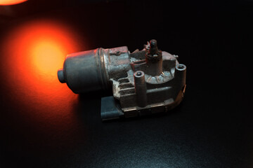 old car wiper motor for windshield cleaning, repair at the service, shooting in a dark room, red...