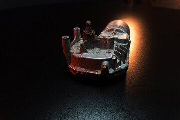 Naklejka premium old car wiper motor for windshield cleaning, repair at the service, shooting in a dark room, red light illumination