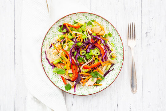 Asian coleslaw with ginger peanut dressing and colorful vegetables