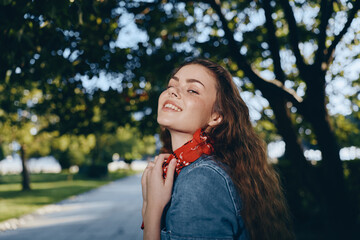 Lifestyle woman in modern boho-western denim street style smiling outdoors with natural sunlight...