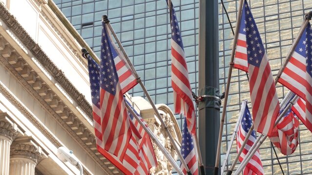 American flags near Grand Central Terminal on 42 street, New York City, Manhattan Midtown. Railway building architecture in United States. Public railroad transport junction. Old station exterior.